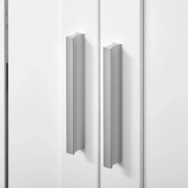 White cabinet door close-up with vertical slatted design and curved pull handles