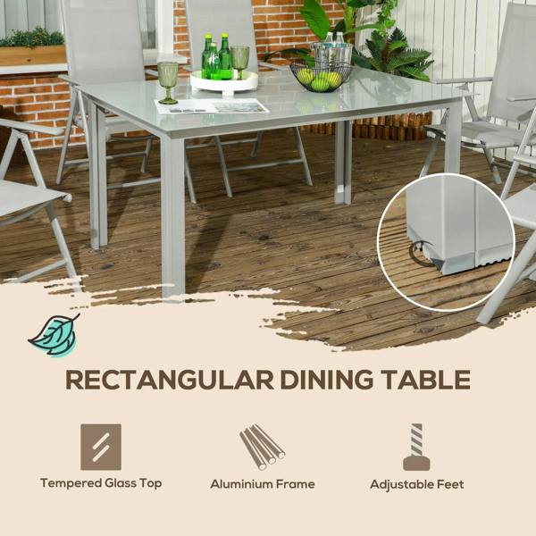 Grey rectangular dining table with tempered glass top and folding reclining chairs.