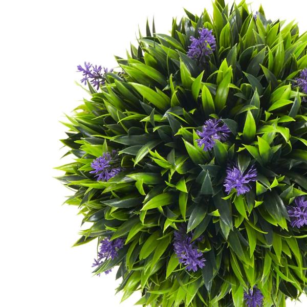 Artificial ball tree plant close-up with green leaves and purple lavender-like flower clusters