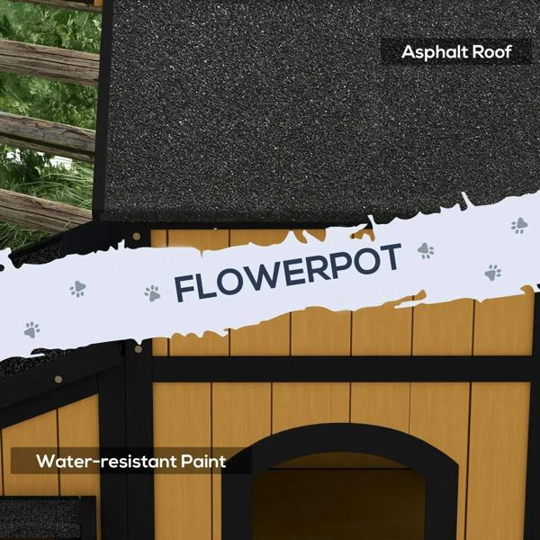 Wooden cat house with black asphalt-style roof and built-in flower pot planter opening