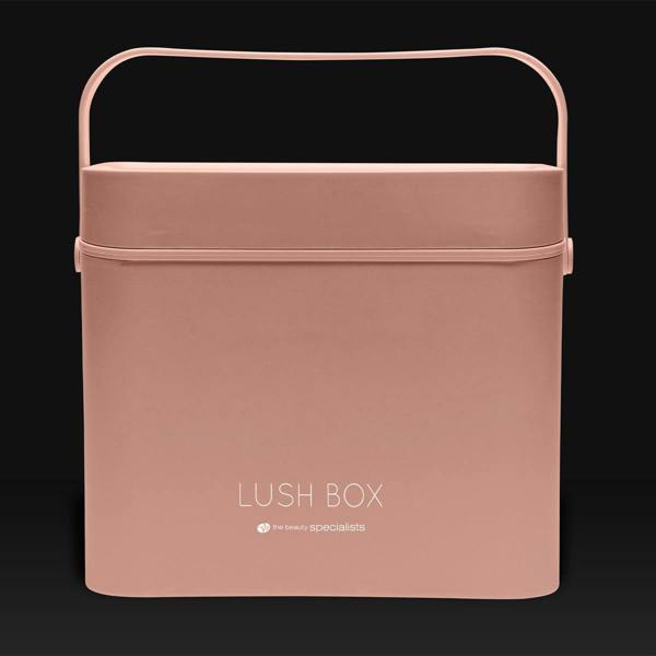 The Rio Lush Box Vanity Case - Large is a rectangular blush pink case with a handle and LUSH BOX plus the beauty specialists on the front, perfect for stylish beauty storage, shown against a dark background.