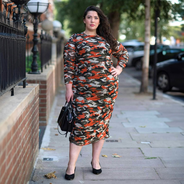 Women's Plus Size Orange Green Grey Camouflage Bodycon Midi Dress styled with a black handbag and black heels for a modern, stylish look.