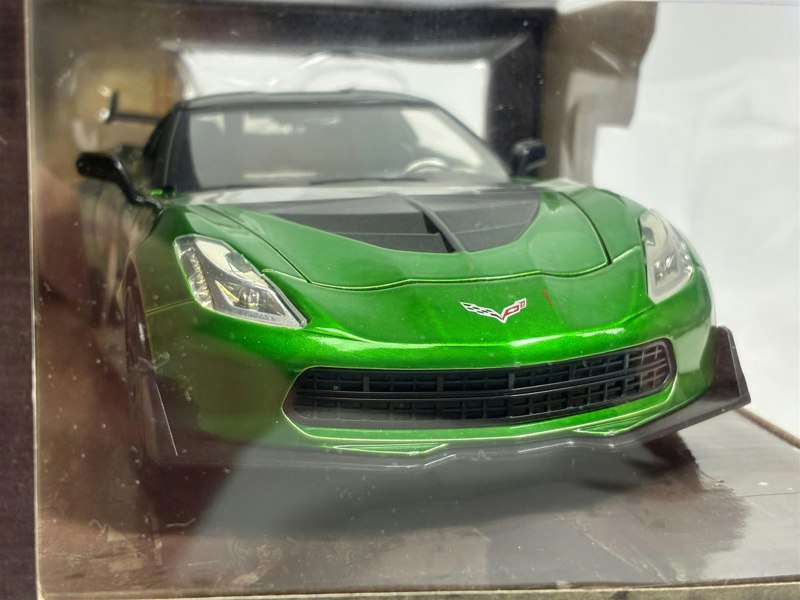 a green sports car in a box