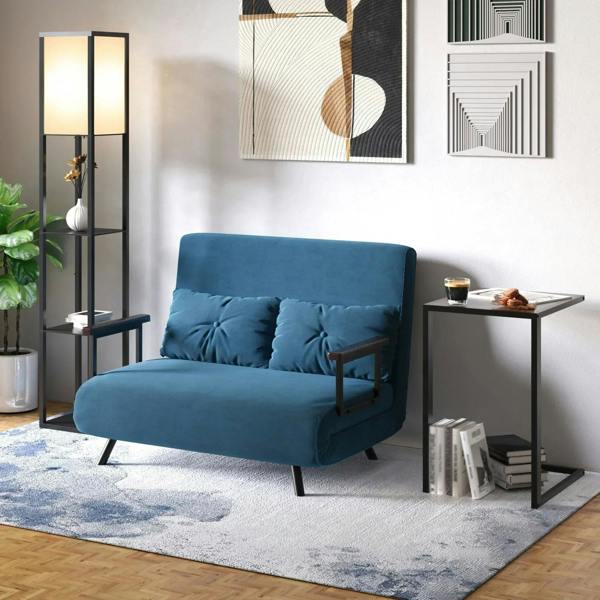 Black floor lamp with top light and shelves beside a sofa