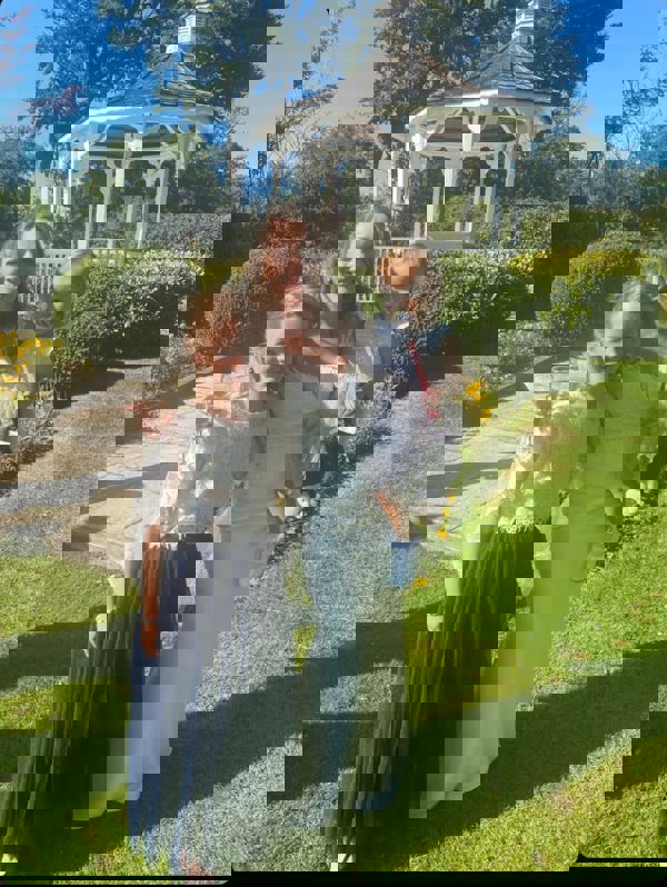 Bride and flower girl in gardens