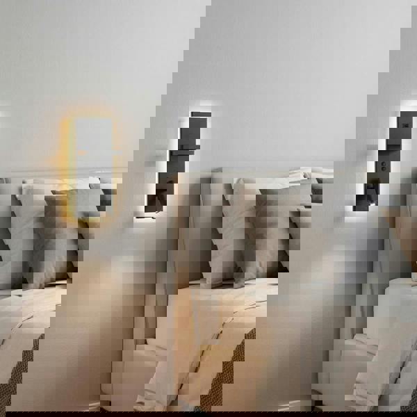 Black bedroom wall lamp with reading light fitted on the wall next to the bed in contemporary minimal bedroom