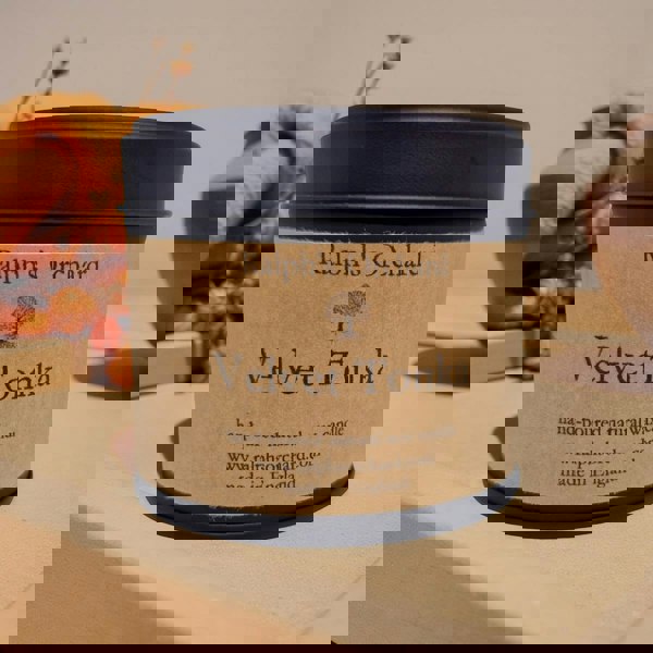 Candle labeled 'Velvet Tonka' from 'Ralph's Orchard' on a neutral background