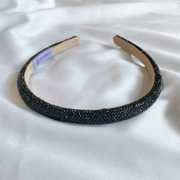 Black hair band, slim design, sparkly crystal embellishments, shimmering finish, comfortable fit, elegant decorative headband
