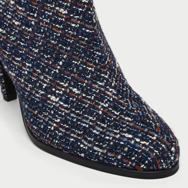 Navy blue tweed Maya ankle boot with a pattern of small white and brown dots on a light gray background tip close-up