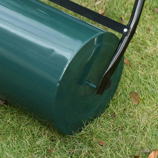 Dark green lawn roller drum with end axle and black frame on grass