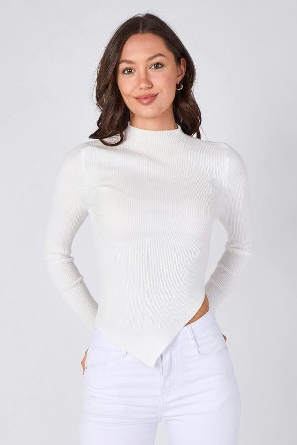 Woman wearing a white ribbed long-sleeve top against a plain background