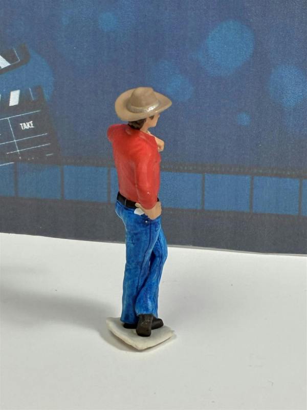 a toy figurine of a man wearing a hat