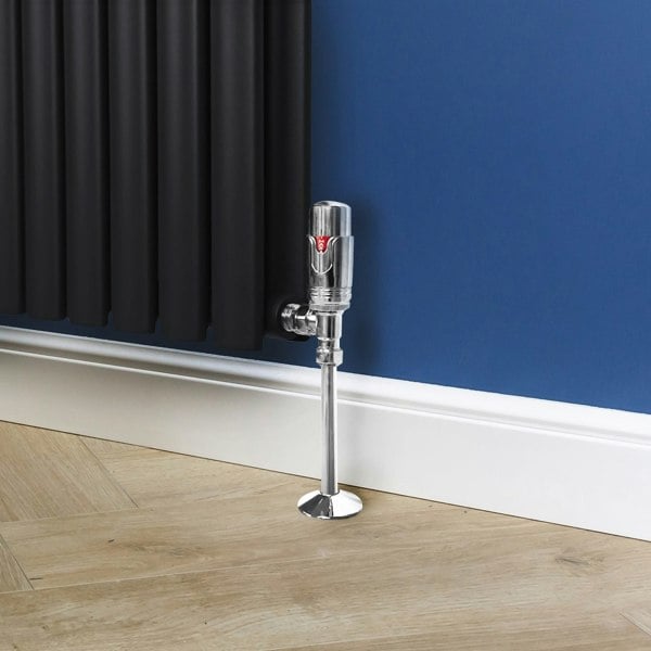 Chrome thermostatic radiator valve with a sleek design, featuring a polished finish and red temperature indicator against a dark wall