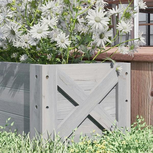 Grey raised garden bed planter with white daisies and cross-brace side