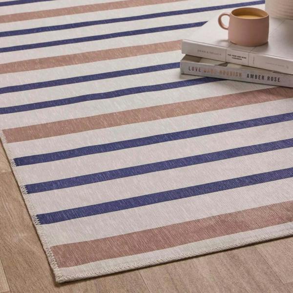 Striped rug with blue and brown stripes on a wooden floor