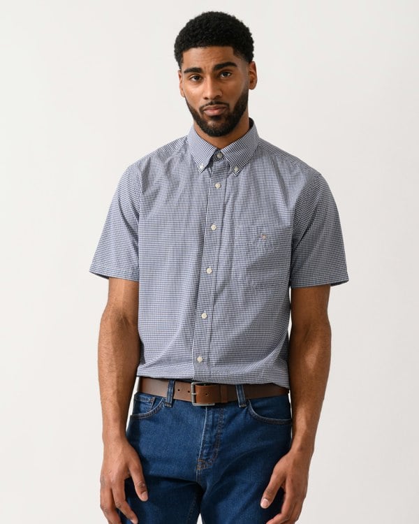Model wearing a GANT Mens Regular Fit Classic Poplin Gingham Short Sleeve Shirt in Persian Blue