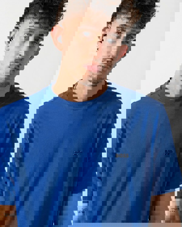 Close up shot of a Model wearing a BOSS Green Tee Mens Stretch Cotton T-Shirt with Contrast Logo in Medium Blue