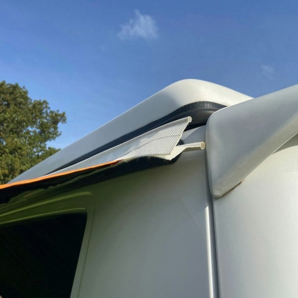 The dual beading on a Cocoon Breeze® v2 Campervan Awning OLPRO, attached to a Volkswagen T5/awning rail. imageset:Charcoal