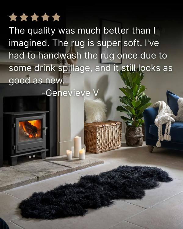 Black Mongolian Sheepskin Rug in front of fireplace