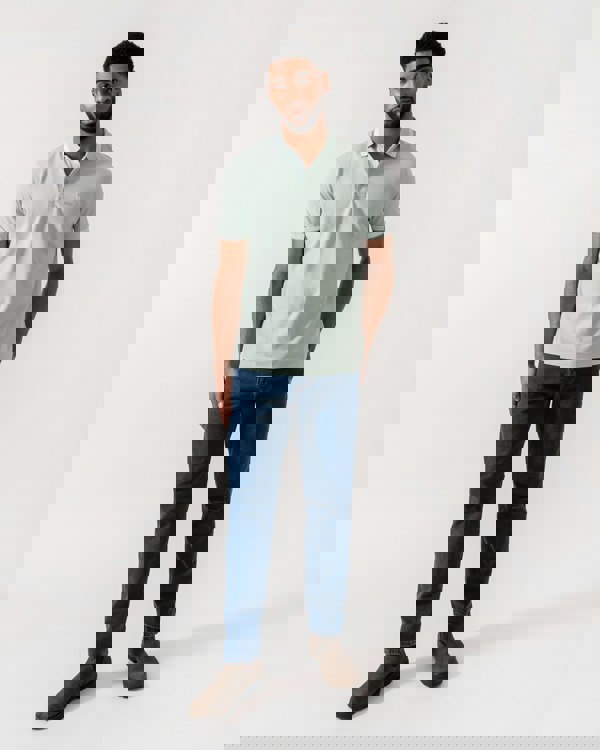 Model wearing BOSS Green Mens Paddy Cotton-Piqué Polo Shirt with Contrast Logo in Turquoise/Aqua 448 - Full Length