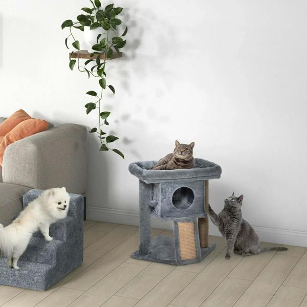Grey cat tree tower with cubby cat house and top perch, with cats resting nearby