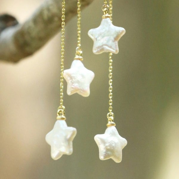 Close up of natural star pearl with gold vermeil chains.