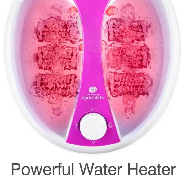 Top-down view of the purple and white Rio Deluxe Foot Spa Bath and Massager filled with bubbling water, featuring the control dial and Rio branding. Text below reads, “Powerful Water Heater.”.