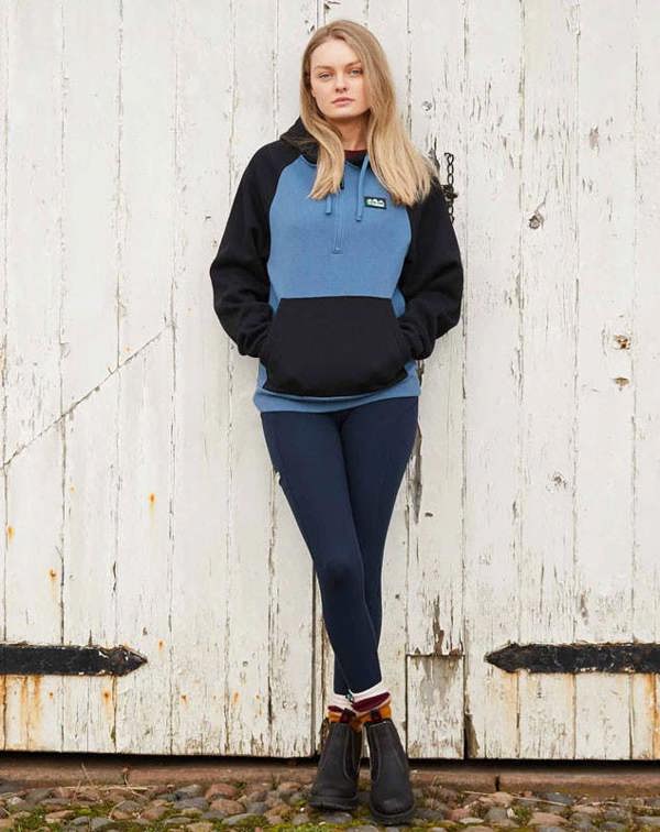 Farmer wearing the Ridgeline Infinity Leggings in Navy with a hoody