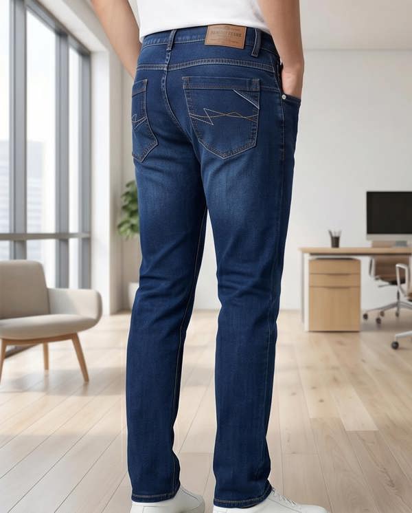 Person wearing blue jeans in a modern office setting