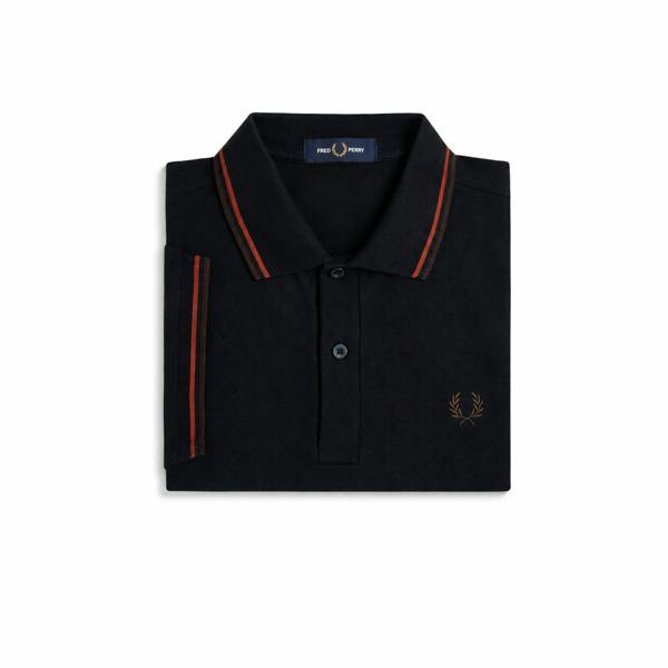 Folded navy Fred Perry twin tipped polo shirt showing the branded neck tape and twin tipped collar.
