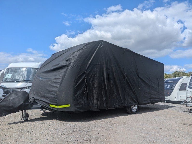 An image of the Breathable Waterproof 4Ply Caravan Cover pitched onto a caravan that is in storage.