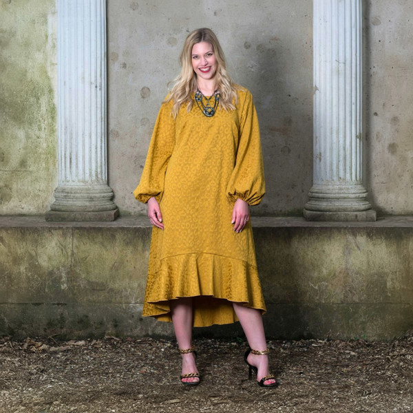 Women's Mid Size Gold Aphrodite Leopard Jacquard Dress with pockets styled with a yellow stone necklace and gold chain heels for an elegant look.