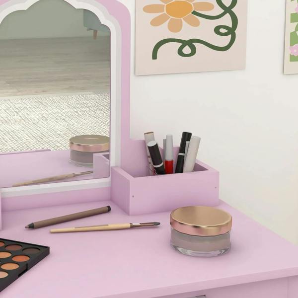 Pink vanity tabletop with mirror shelf, makeup items, and brush holders