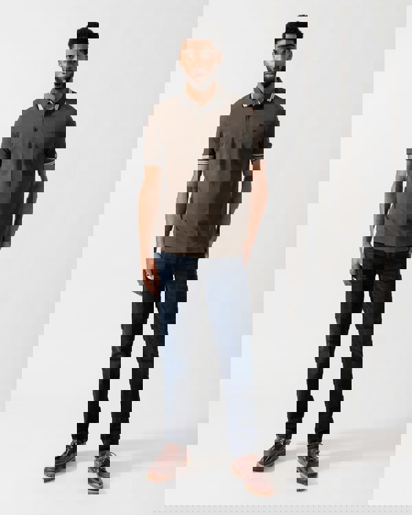 Model wearing BOSS Green Mens Paddy Cotton-Piqué Polo Shirt with Contrast Logo in Open Beige 297 - Full length