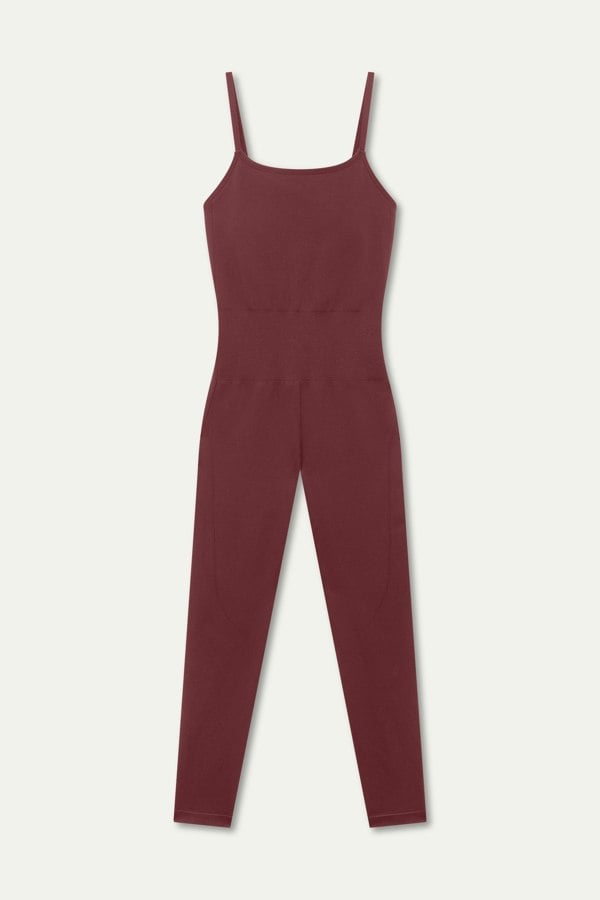 Red burgundy one-piece with adjustable straps, low cross-back design, removable pad and sculpting fit, crafted from recycled polyamide for a secure and flexible fit. Perfect for gym workouts, Pilates, or layering for casual wear.