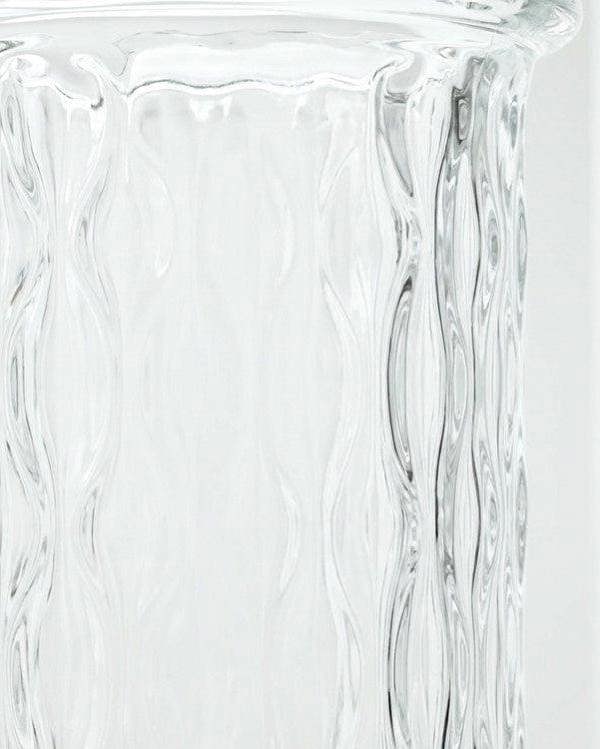 Clear glass vase with textured design on a white background