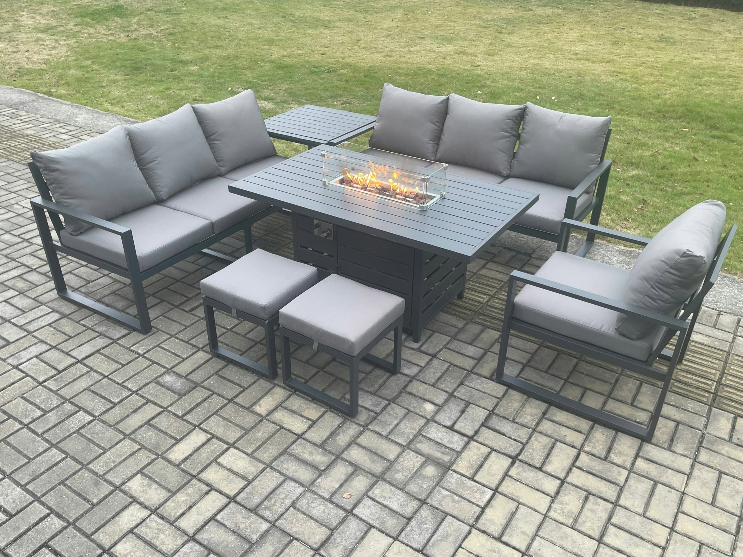 Rackhams Dark/Grey Aluminium 7 Pieces Garden Furniture Sofa Set With Cushions 9 Seater Gas Fire Pit Dining Table Set With Side Table 2 Small Footstools