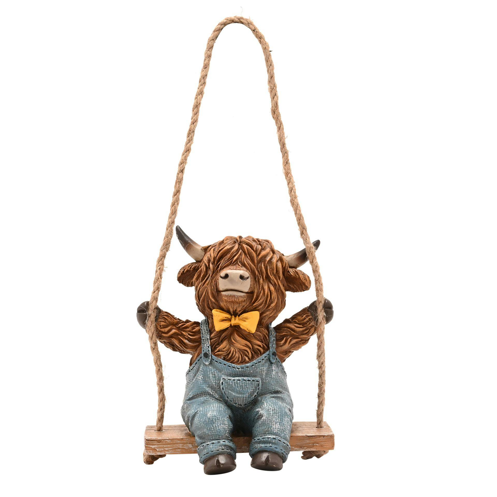 Rackhams Light/Brown/Yellow Highland Cow On A Swing