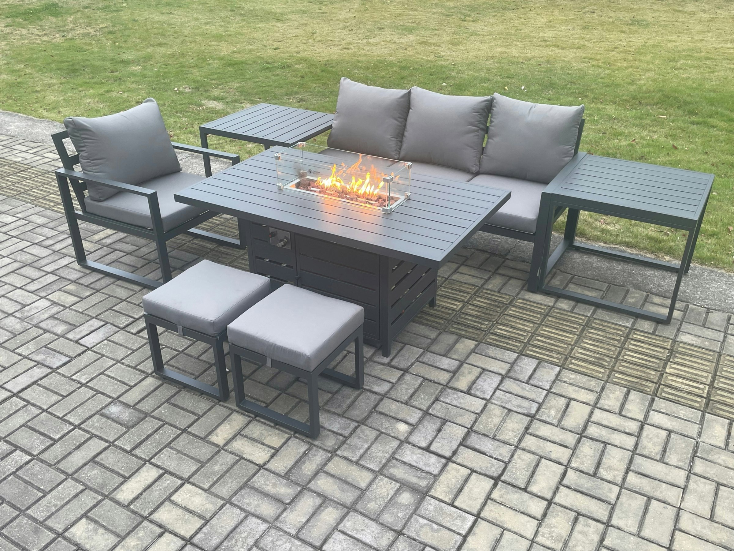 Rackhams Dark/Grey Aluminium 7 Pieces Garden Furniture Sofa Set With Cushions Gas Fire Pit Dining Table Set With 2 Small Footstools 2 Side Tables