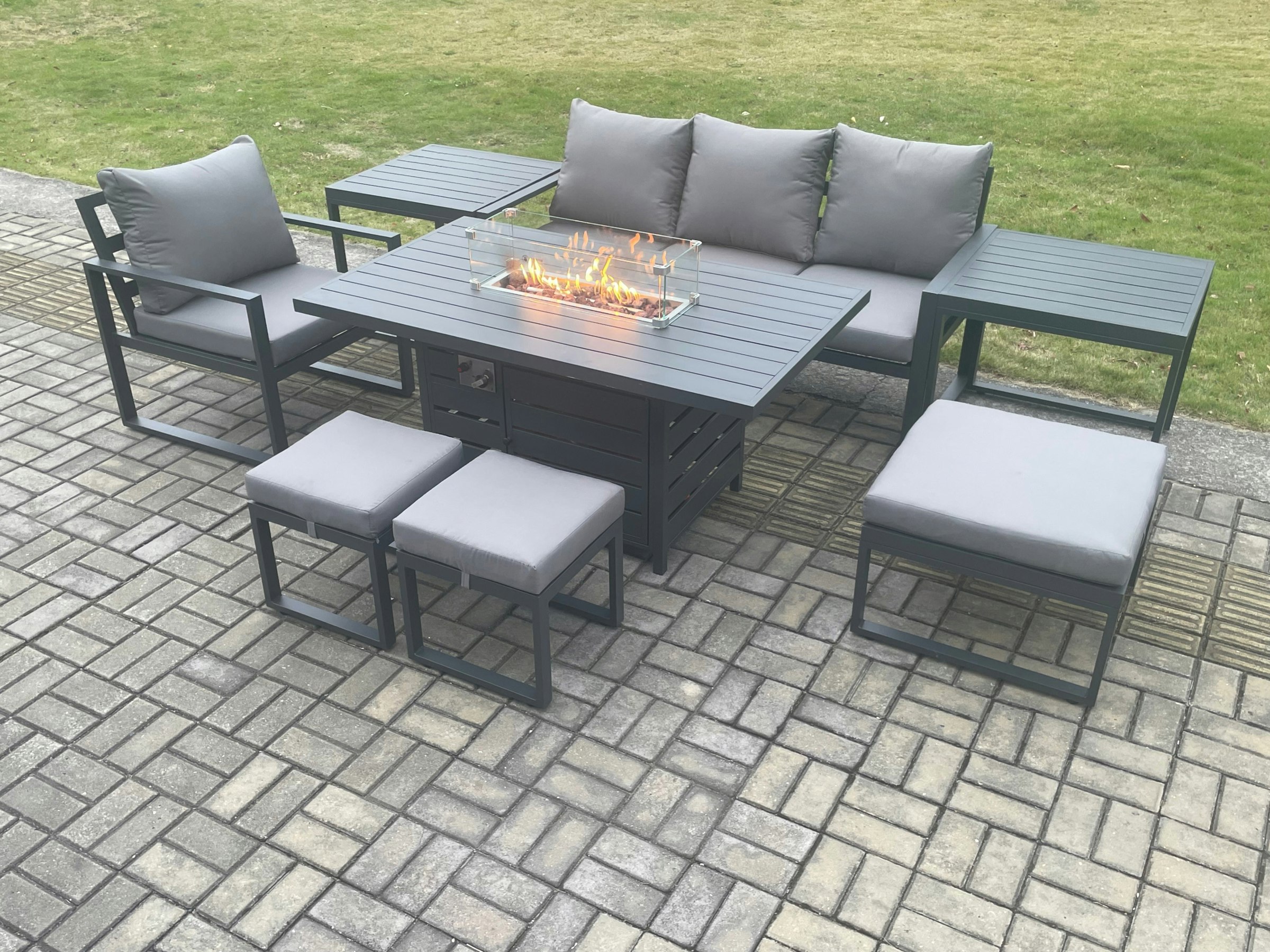 Rackhams Dark/Grey Aluminium 8 Pieces Garden Furniture Sofa Set With Cushions Gas Fire Pit Dining Table Set With 3 Footstools 2 Side Tables